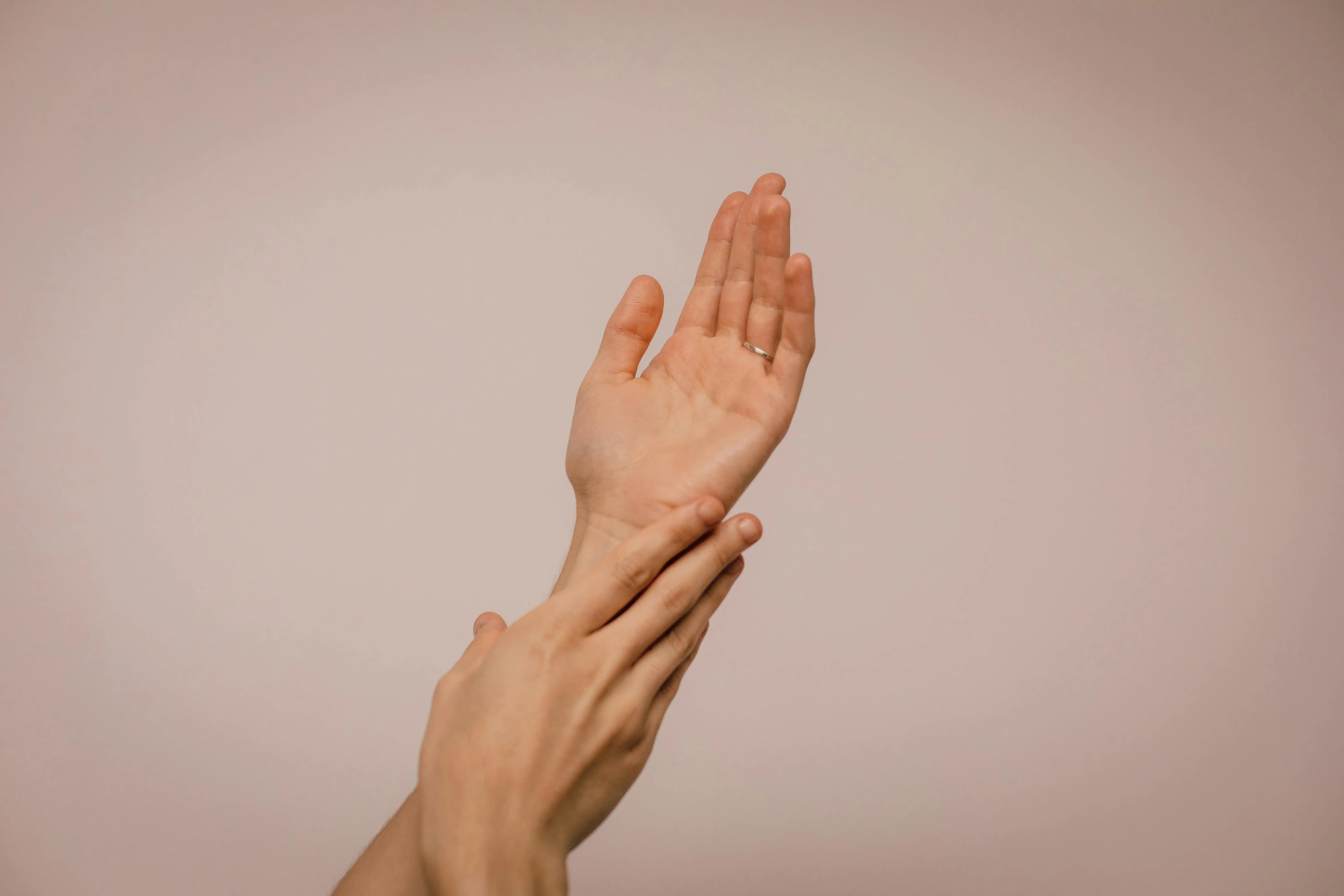 Close up of womens hands applying moisturizer
