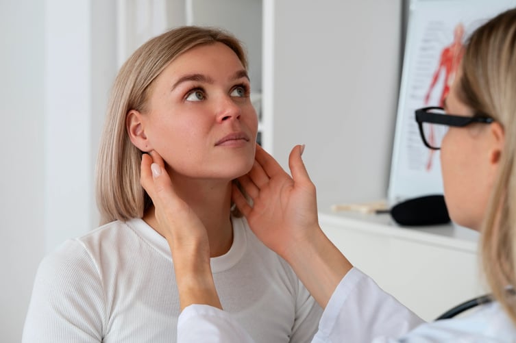 Doctor examining women for where botox should be injected for TMJ