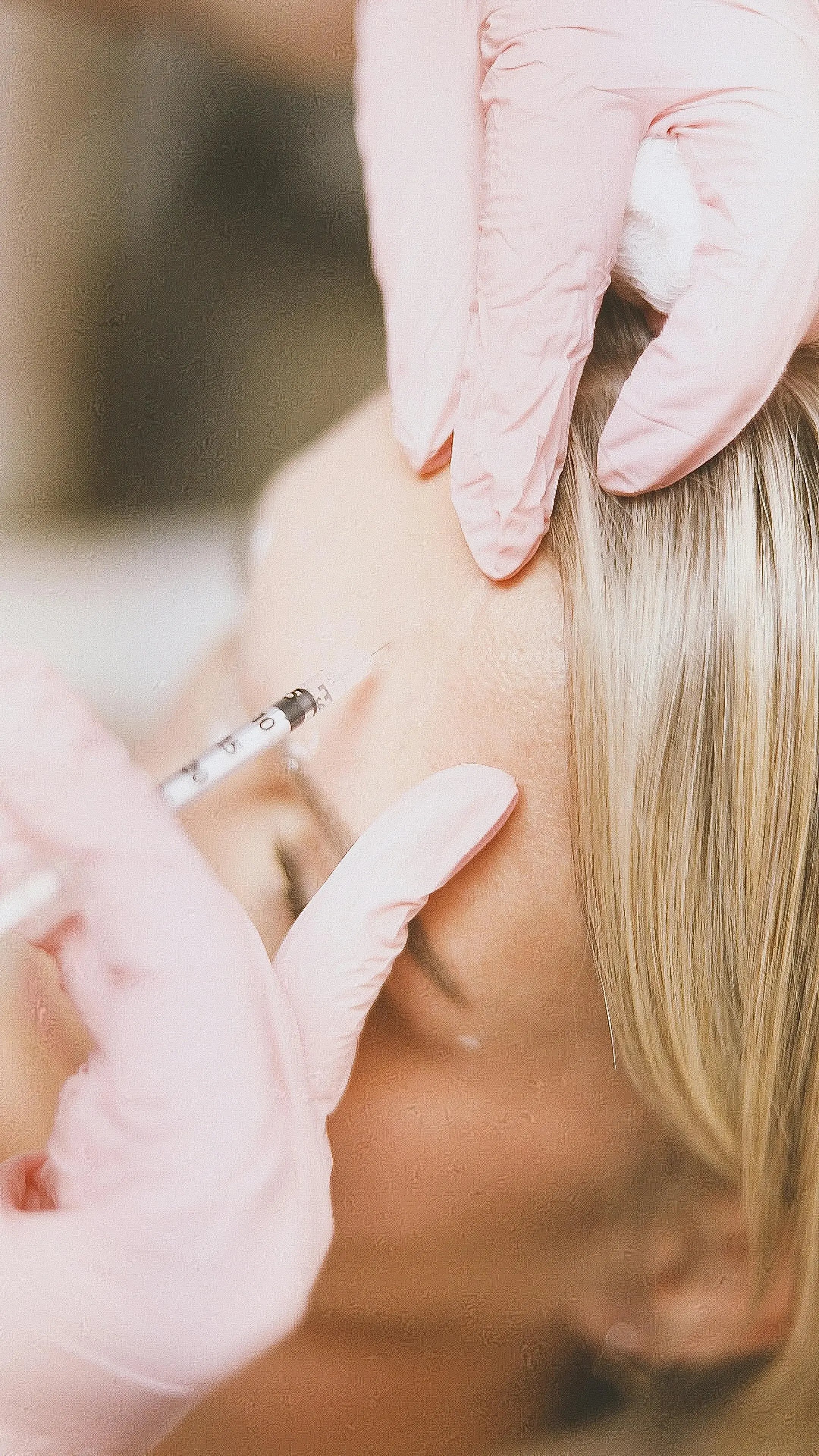 Doctor placing botox in forehead