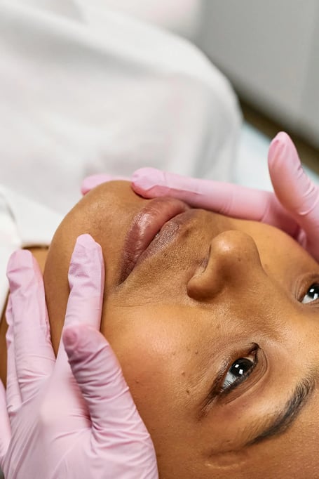 close up of injector prepping clients face before treatment