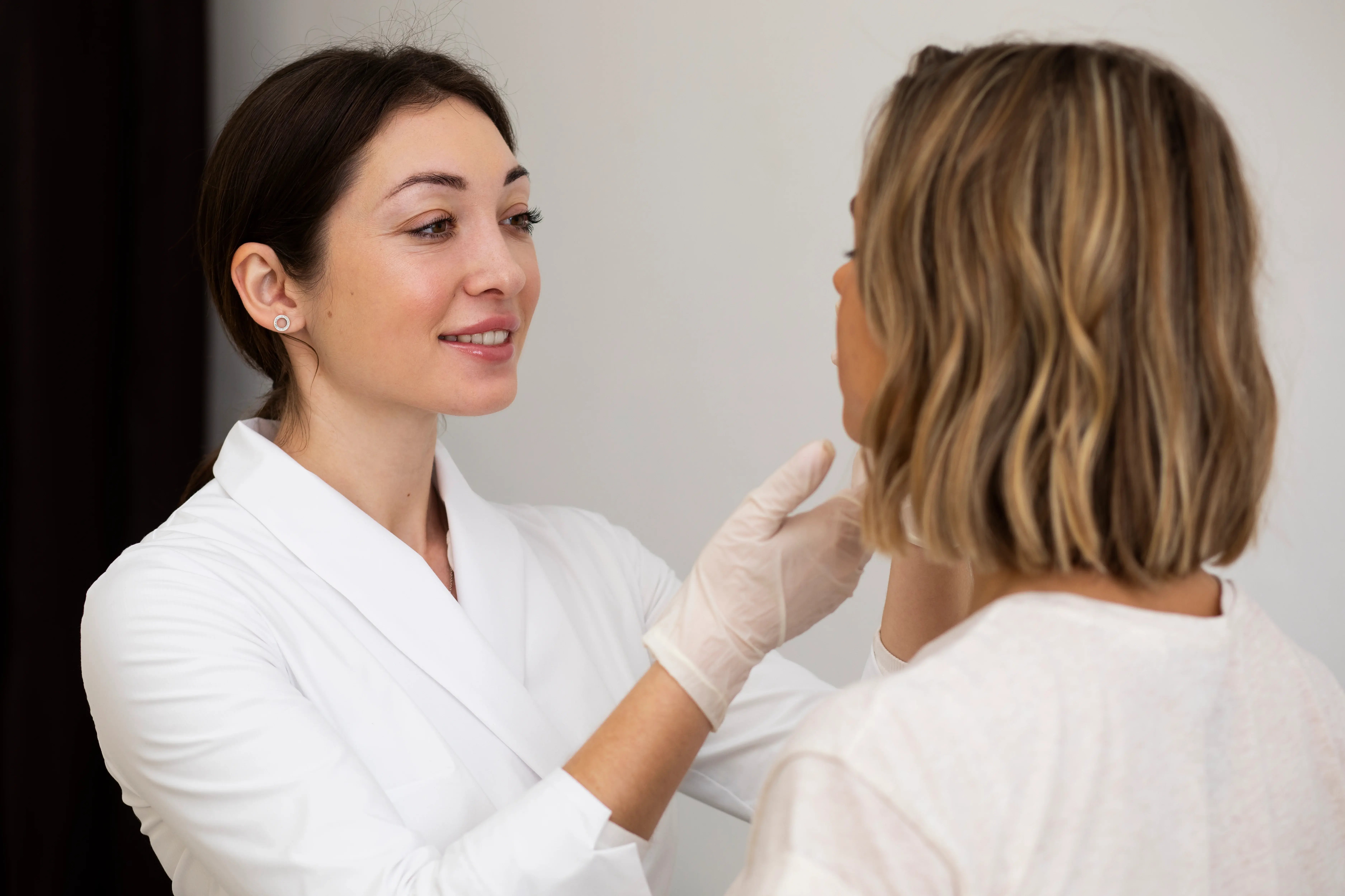 doctor analyzing a womens acne before treatment