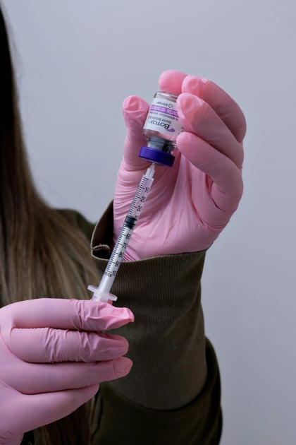 doctor filling botox syringe in prep for treatment