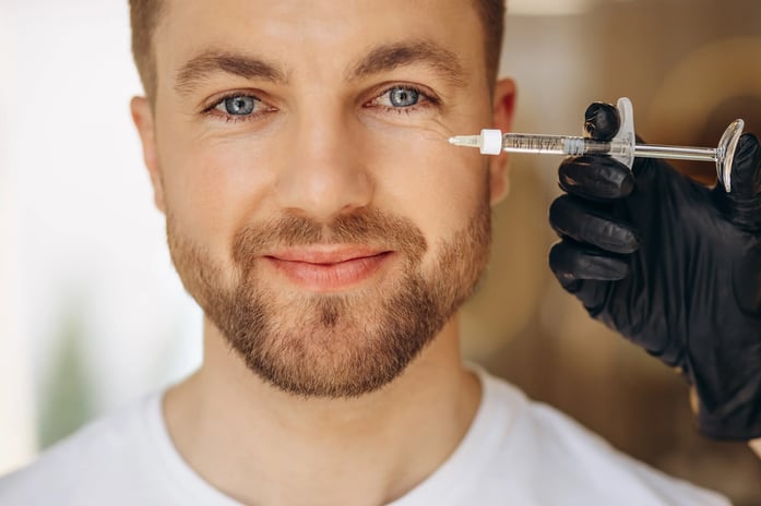 man getting injectables for under eyes
